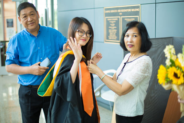 Master's in Supply Chain Management graduate with her parents