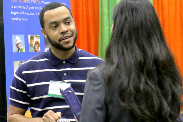 UT dallas student talking with a recruiter about bs in supply chain management internship options